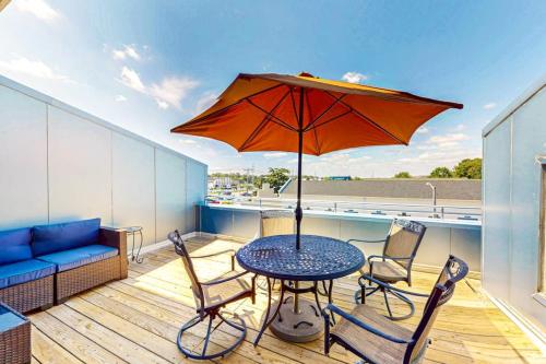 a patio table with an umbrella on a balcony at Rehoboth Beach --- Forj Lofts, Unit #2 in Rehoboth Beach