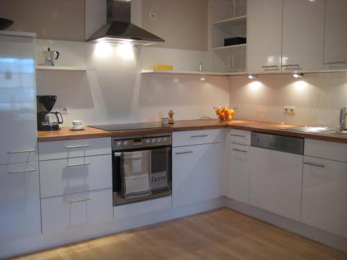 a kitchen with white cabinets and a stove top oven at Ferienwohnung-VS in Villingen-Schwenningen