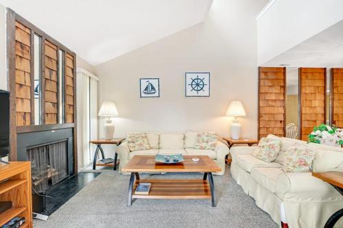 a living room with a couch and a fireplace at Sea Colony - 802 Wimbledon in Bethany Beach