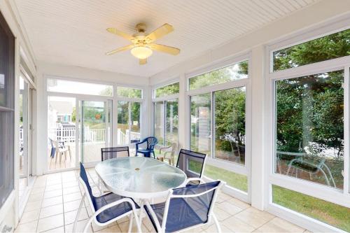 a screened in porch with a table and chairs at Bear Trap Dunes - 2 October Glory in Ocean View