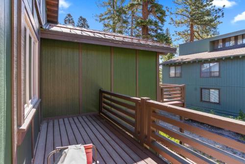 a deck with a green building and a house at 4BR Townhome Near Canyon Lodge & Lakes Basin in Mammoth Lakes