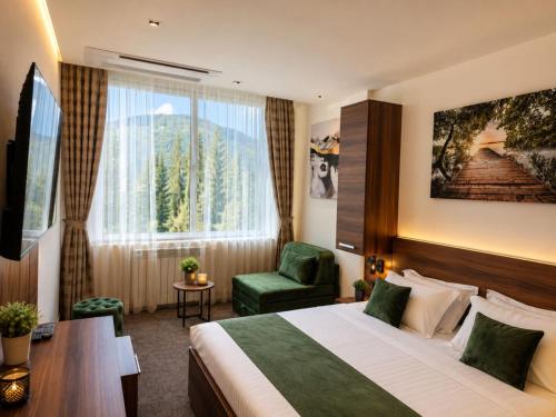 a hotel room with a bed and a chair at Hotel Luka's in Berane