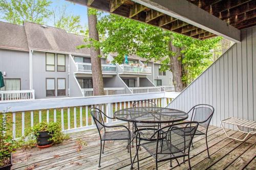 a patio with a table and chairs on a deck at Sea Colony - 3306 Round Robin Way in Bethany Beach