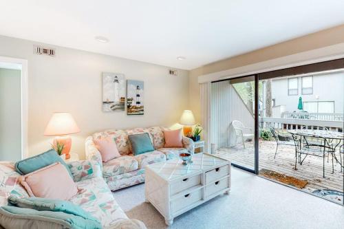 a living room with a couch and a table at Sea Colony - 3306 Round Robin Way in Bethany Beach