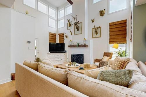 a living room with a large couch and a fireplace at Sea Colony - 58011 Wimbledon in Bethany Beach