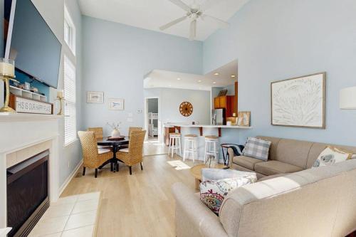 a living room with a couch and a dining room at Bayside Resort - 36295 Sunflower in Selbyville