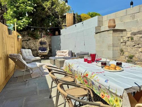 a table with a plate of food on a patio at Shrubbery Lodge - Games Room & Patio Dining in Wyke Regis