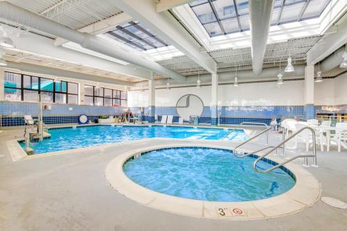 a large swimming pool with blue water in a building at Sea Colony - 2004 Doubles in Bethany Beach