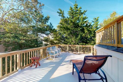a deck with two chairs and a table on it at Sea Del Estates - 38 Sugar Hill in Bethany Beach