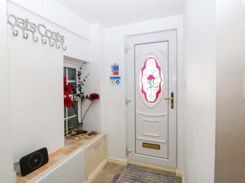 a room with a white door with a window at Farm Cottage in Cemaes Bay
