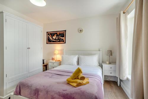 a bedroom with a bed with a yellow towel on it at 3 Bed in Mumbles oc-m33090 in The Mumbles