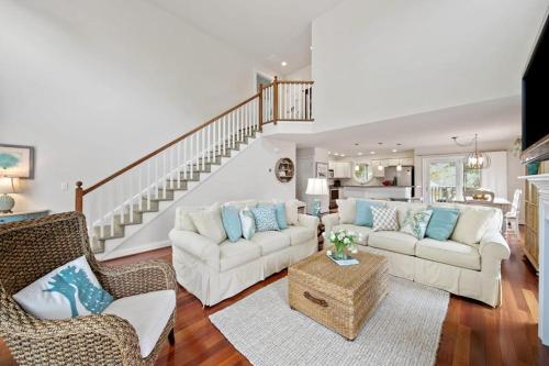 a living room with two white couches and a staircase at Bethany West -- 719 Fenwood in Bethany Beach