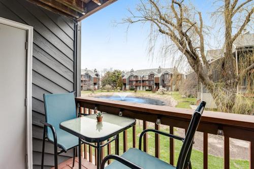 a balcony with a table and chairs and a view of a pool at Eagles Landing I --- 260 Sea Eagle Dr Unit 7 in Rehoboth Beach