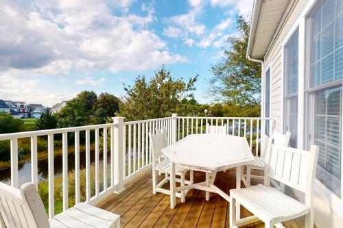 a wooden deck with a table and chairs on a house at Bear Trap Dunes - 58D October Glory in Ocean View