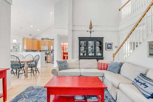 a living room with a white couch and a red table at Bear Trap Dunes - 60 Willow Oak in Ocean View