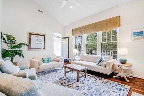 a living room with two couches and a table at Bear Trap Dunes --- 83F October Glory Dunes in Ocean View