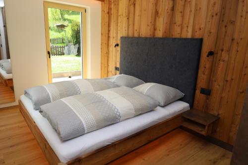 a bed sitting in a room with a window at Apartments Silvonia in Pallua