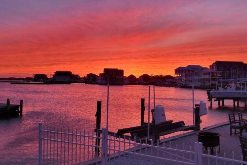 a sunset over a body of water with a dock at West Fenwick --- 39110 Van Buren Ave in Selbyville