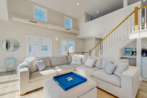 a living room with a couch and a staircase at South Bethany --- 102 Brandywine Dr in Bethany Beach