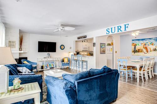 a living room with blue couches and a kitchen at Sea Colony - 903 Singles Ct in Bethany Beach