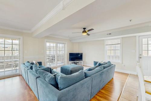 a large blue couch in a living room with windows at Edgewater Acres --- 39157 Garfield Ave in Selbyville