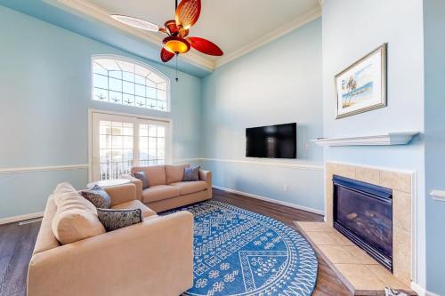 a living room with a couch and a fireplace at Bayside at Bethany Lakes #143 in Ocean View