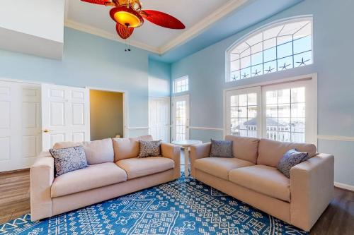 a living room with two couches and a rug at Bayside at Bethany Lakes #143 in Ocean View