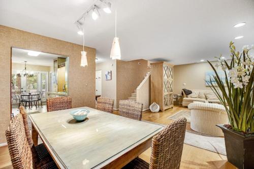 a dining room and living room with a table and chairs at Sea Colony - 52028 Canal Ct in Bethany Beach