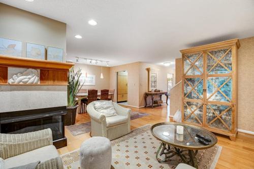a living room with a fireplace and a living room with a table at Sea Colony - 52028 Canal Ct in Bethany Beach