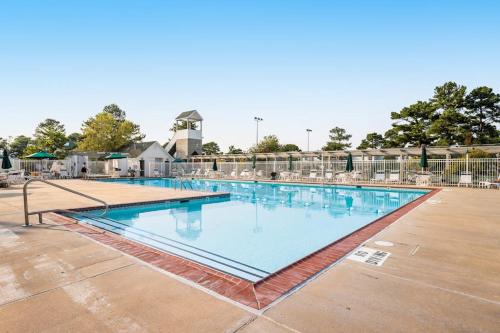 a large swimming pool with blue water at Mallard Lakes - 142 Cardinal in Selbyville