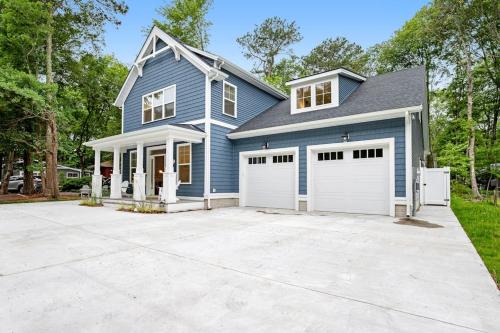 a blue house with a white garage at Bethany West --- 557 Fairway in Bethany Beach