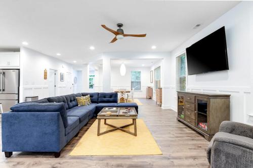 a living room with a blue couch and a tv at Bethany West --- 557 Fairway in Bethany Beach