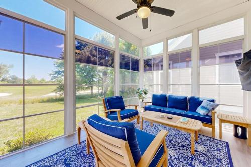 a living room with blue furniture and large windows at Bear Trap Dunes - 67 Willow Oak in Ocean View