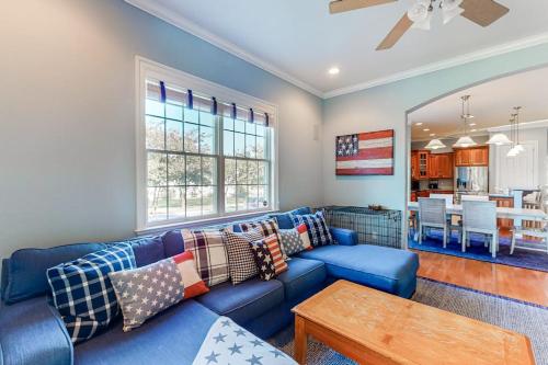 a living room with a blue couch and a table at Bayside Resort - 36486 Wild Rose in Selbyville
