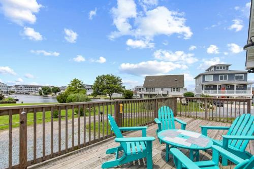 a deck with blue chairs and a table at Fenwick Island -- 28 High Tide in Fenwick Island