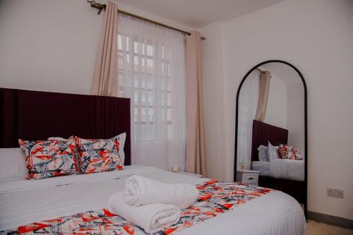 a bedroom with a bed with a towel on it at Parma Staycation in Rungiri