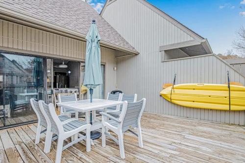 a table and chairs with a umbrella on a deck at Sea Colony - 6301 Private in Bethany Beach