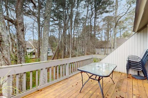 a patio with a table and chairs on a deck at Sea Colony --- 2203 Round Robin in Bethany Beach