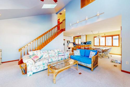 a living room with a blue couch and a table at South Bethany --- 301 W 2nd St in Bethany Beach