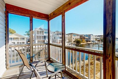 a porch with two chairs and a view of the water at South Bethany --- 301 W 2nd St in Bethany Beach