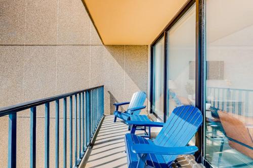 two blue chairs sitting on a balcony at Sea Colony - 708 Brandywine House in Bethany Beach