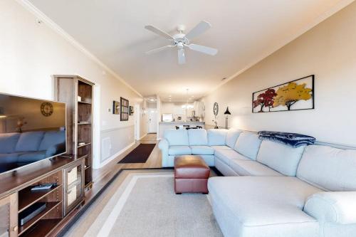 a living room with a couch and a tv at The Tides -- 20007 Sandy Bottom # 4202 in Rehoboth Beach