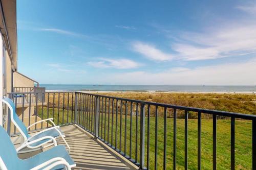 two chairs sitting on a balcony looking at the beach at Sea Colony - 2F Brandywine Garden Rd in Bethany Beach
