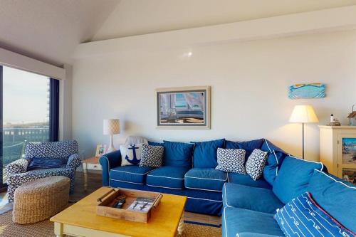 a living room with a blue couch and a table at Sea Colony - 2F Brandywine Garden Rd in Bethany Beach