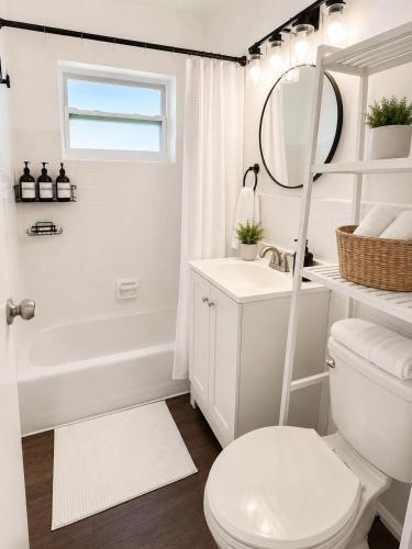 a bathroom with a toilet and a sink and a mirror at Las Palmas in Biscayne Seaplane Base