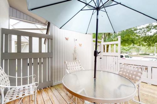 a patio with a table and chairs and an umbrella at Sea Colony - 9603 Timberlake in Bethany Beach