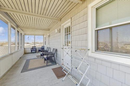 a porch with chairs and tables and a window at 37534 Lighthouse Rd #202 in Fenwick Island