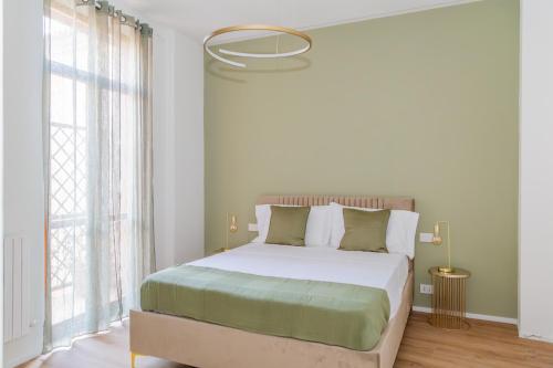 a bedroom with a bed and a large window at Orefici's Home in Ancona