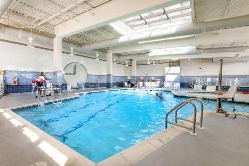 a large indoor swimming pool with people in it at Sea Colony - 507 Georgetown House in Bethany Beach