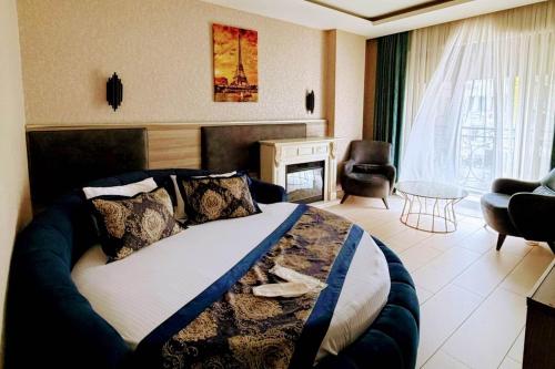 a bedroom with a bed and a living room at Restwon Suite Hotel in Istanbul